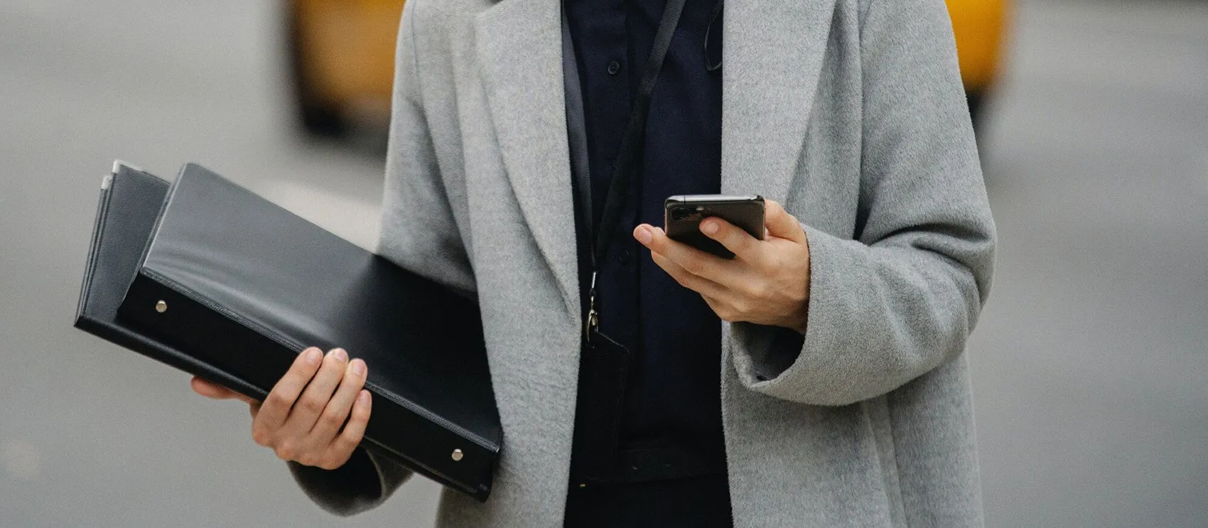 Manager with folders and phone in hand