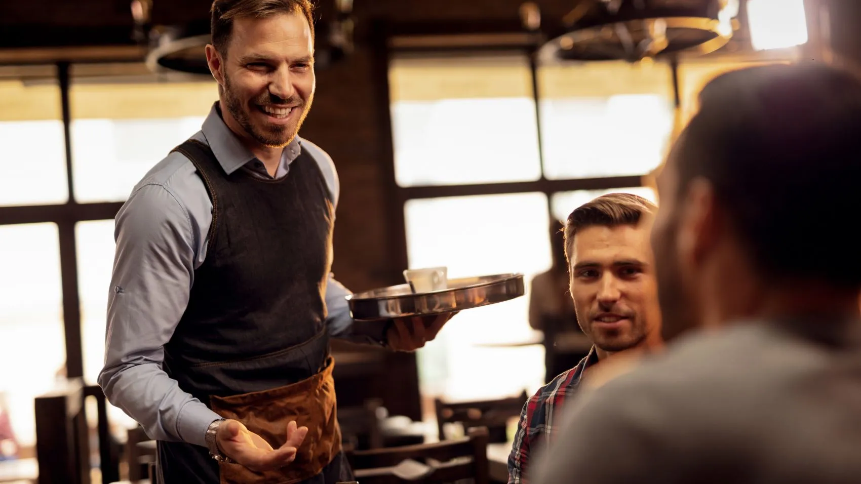 Waiter and clients in a restaurant